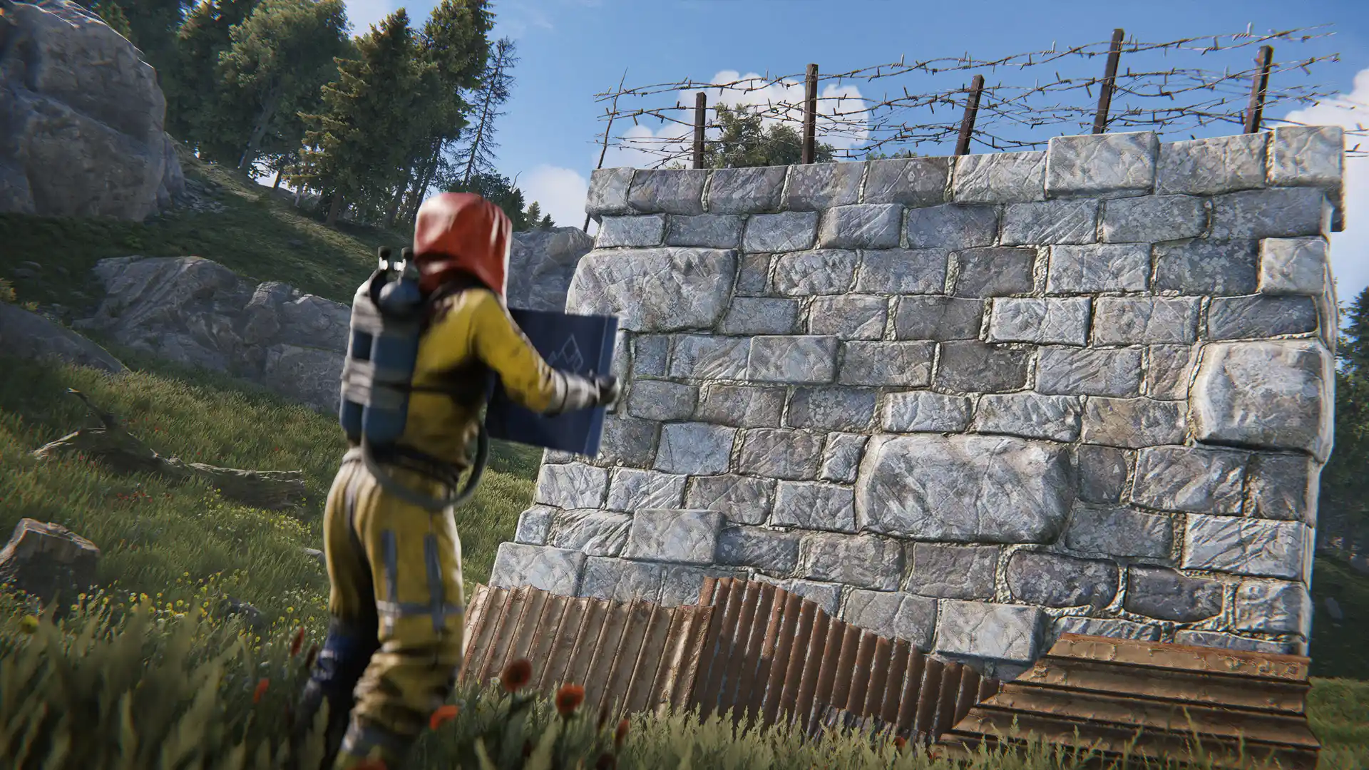 Rust player placing a high external stone wall